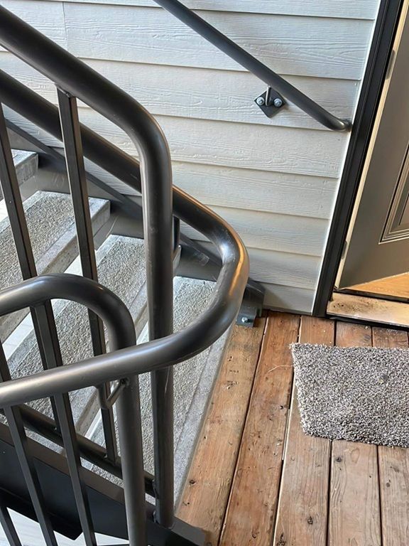 Curved handrail apartment complex close up image Jory